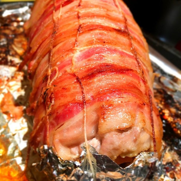 bacon wrapped stuffed pork on baking pan