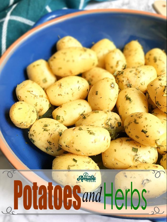 boiled potatoes and herbs in a bowl on a table