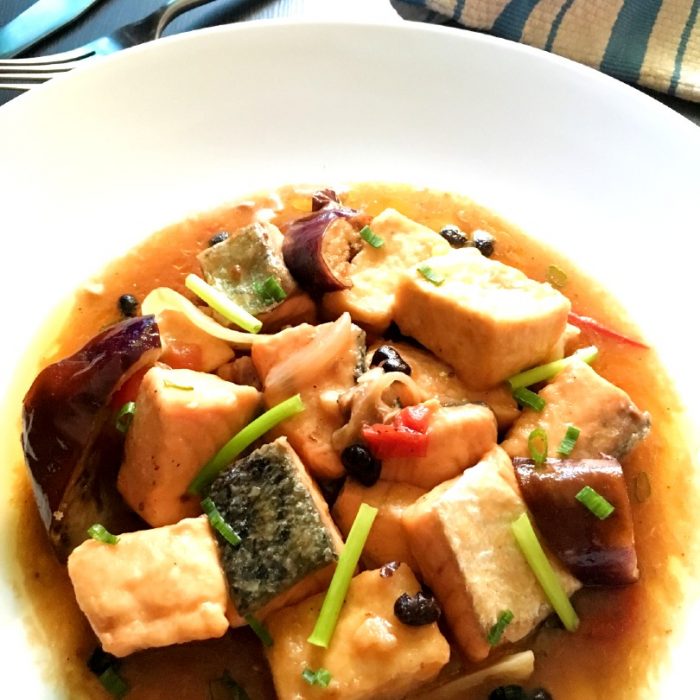 close up of salmon and tofu with tausi