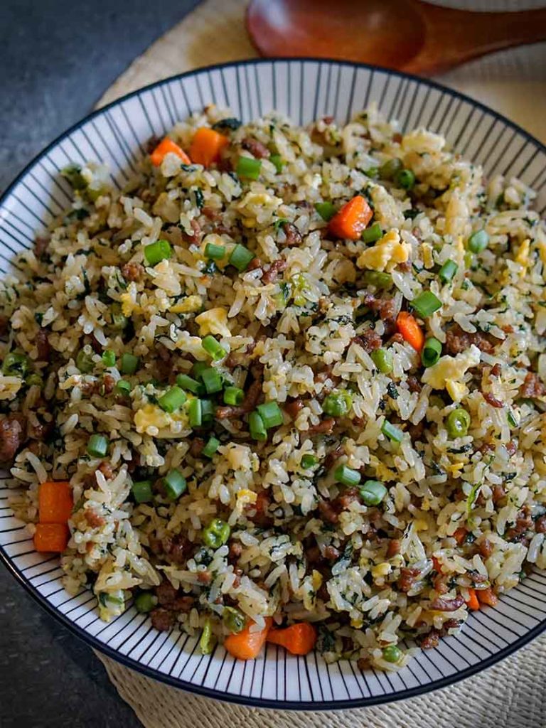 cooked rice with beef and vegetables in a plate