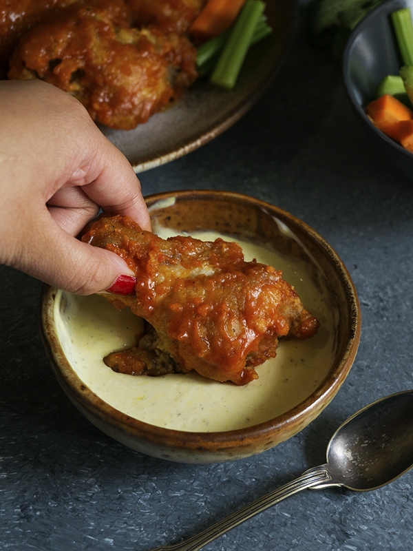 chicken wing dipped in sauce
