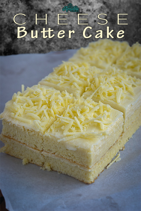 cake tpped with butter frosting and grated cheese