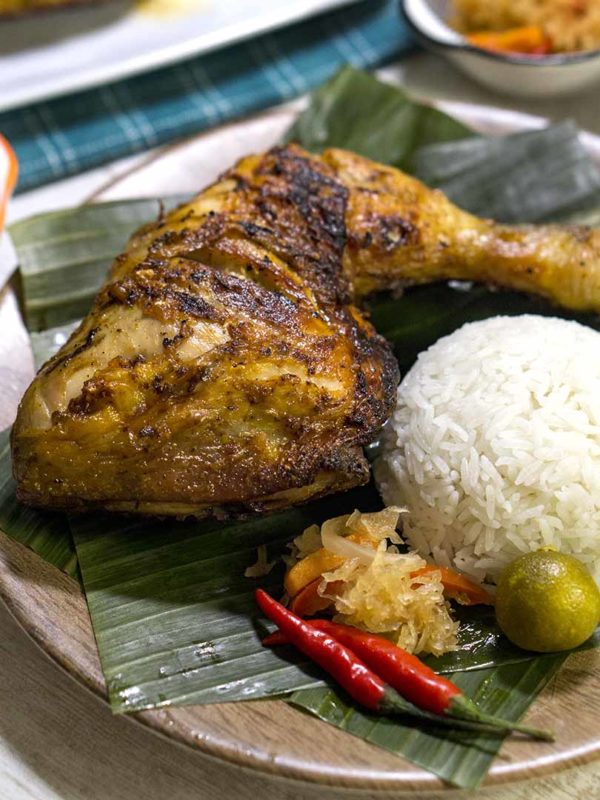 grilled poultry with rice in a plate on top of table