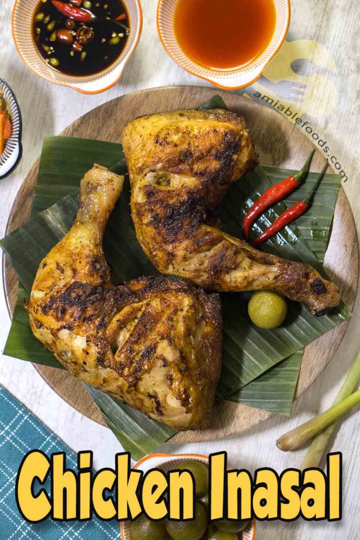 grilled poultry on banana leaves in a plate with chili and lime