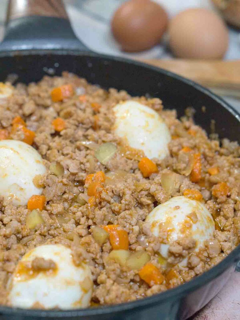 stew with eggs in a pan