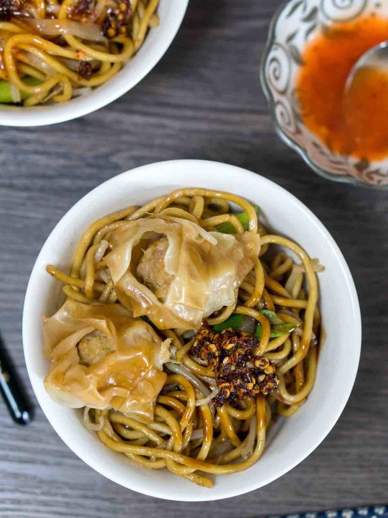 noodles with sauce and topping on top of table
