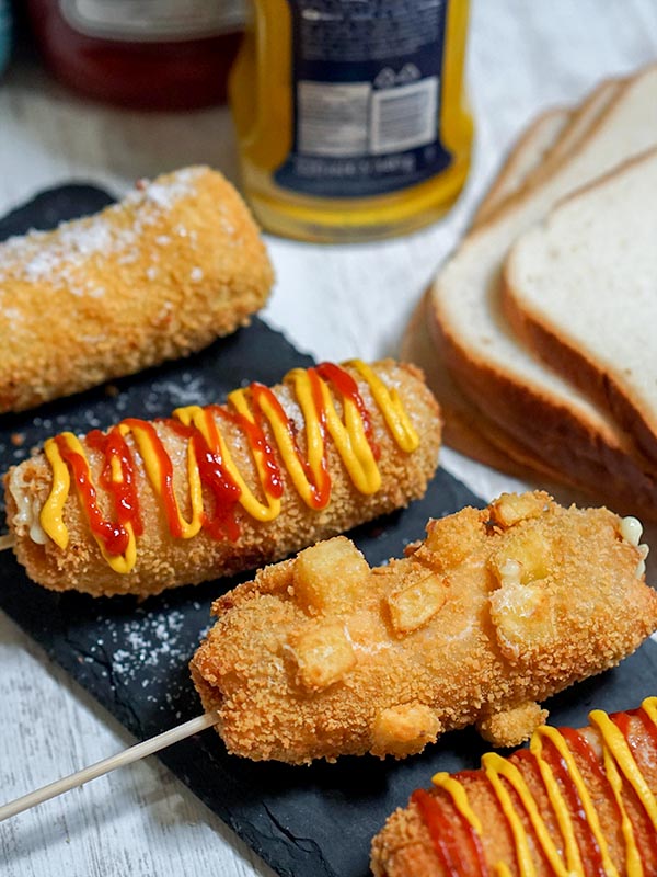bread stuffed with hotdogs with ketchup and mustard