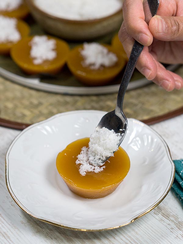 grated coconut placed on top of dessert using spoon