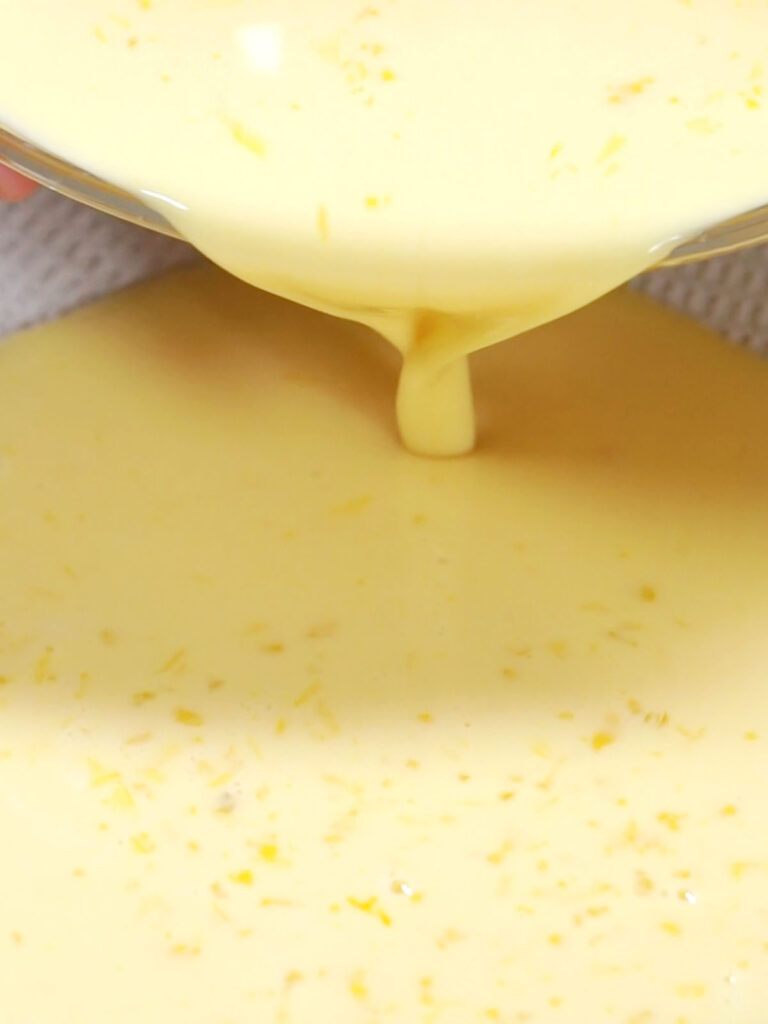 custard being poured in a bowl