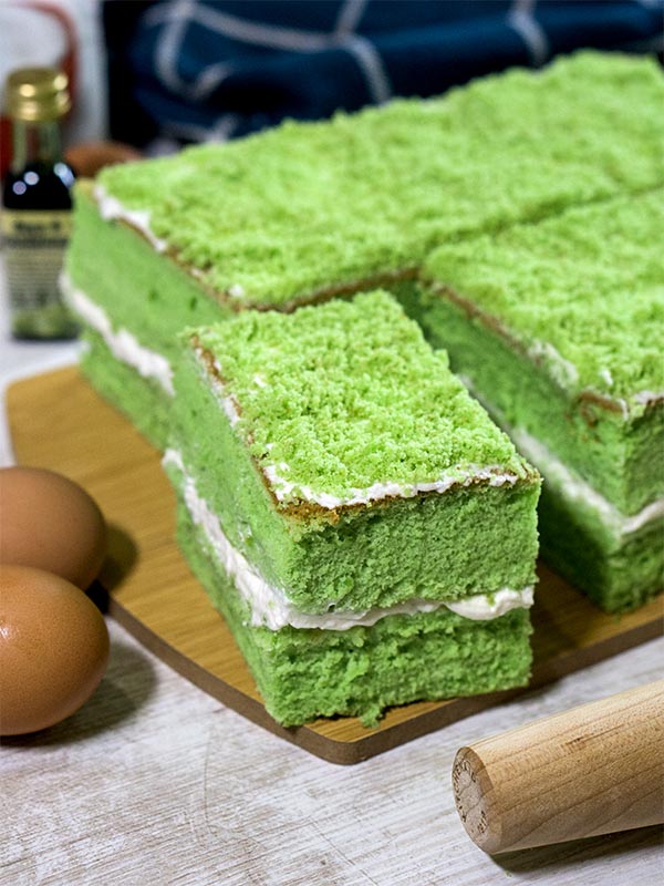 green pastry with cream filling in a board with eggs on the side