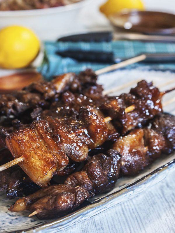 pork skewers with BBQ sauce on table