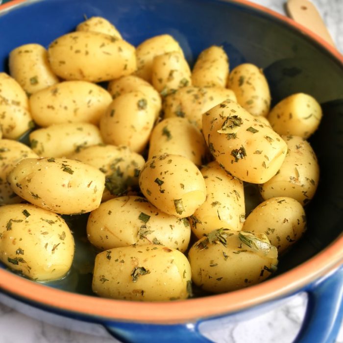 boiled potatoes and herbs on table