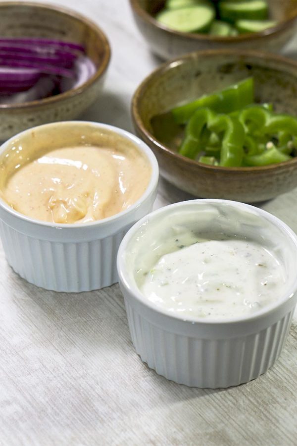 spicy condiment and white sauce in bowls on top of table