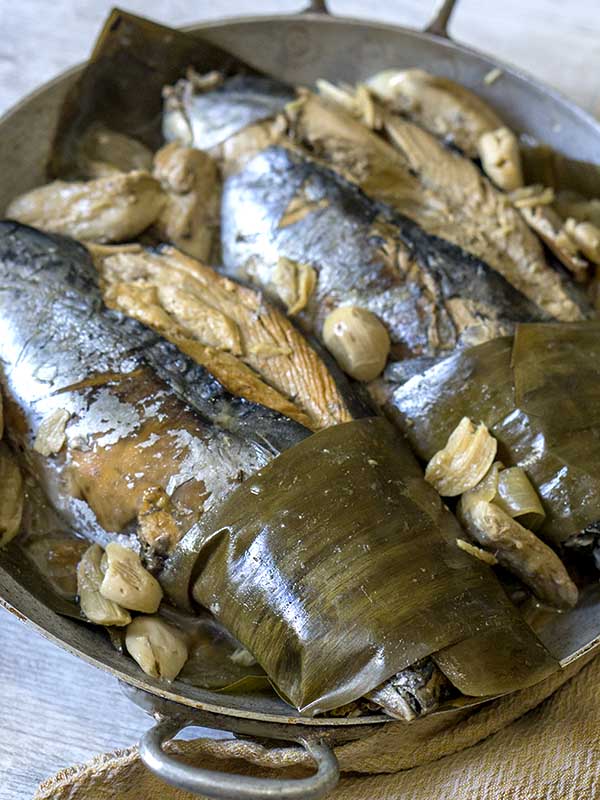cooked fish wrapped in banana leaves