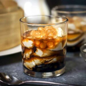 pudding with syrup and toppings in a glass